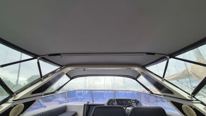 Een interieur van een boot met een grijs dak, een stuur en een dashboard met meters. — Sunseeker 38 Martinique