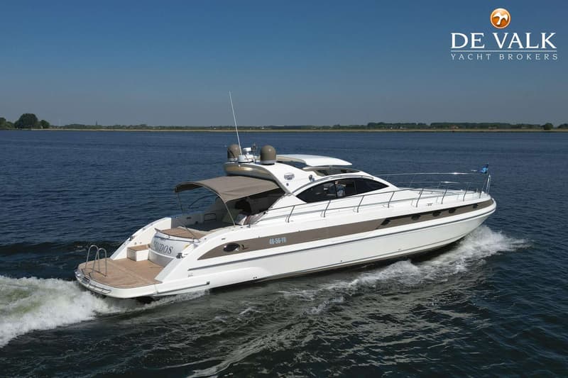 Een witte motorboot met bruine accenten vaart op een waterweg onder een helderblauwe lucht. — Conam 58 Sport HT