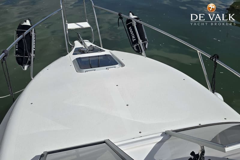 De foto toont de boeg van een witte boot met een ankerlier, een luik, twee zwarte fenders en een reling. — Öchsner SR 25