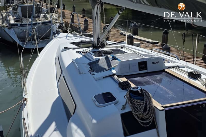 Een witte zeilboot ligt aangemeerd aan een houten steiger, met zonnepanelen en een B&G-instrument op het dek. — Hanse 315