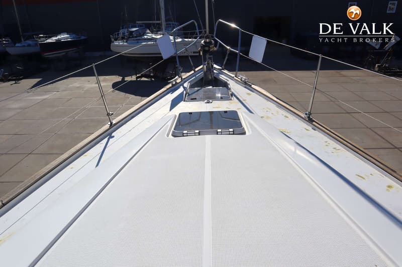 De foto toont het voordek van een zeilboot met twee luiken, omringd door relingen en een ankerlier. — Bavaria 42 Exclusive