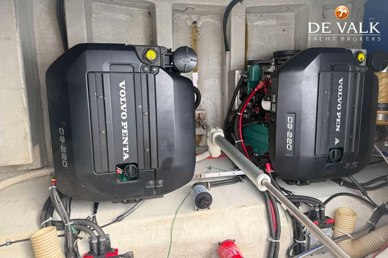 Twee Volvo Penta D3-220 motoren zijn zichtbaar in een motorruimte, met kabels en leidingen eromheen.