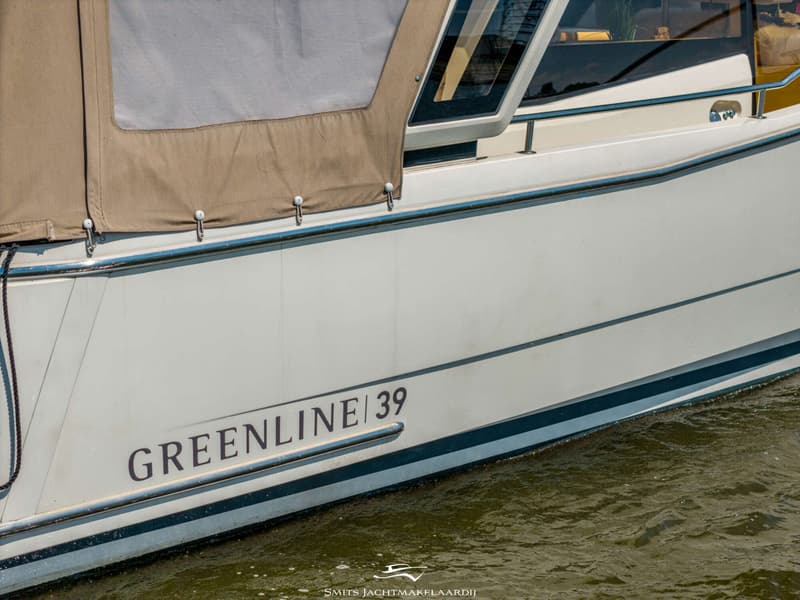 De zijkant van een witte boot met de tekst "GREENLINE / 39" en een beige afdekzeil. — Greenline Greenline 39