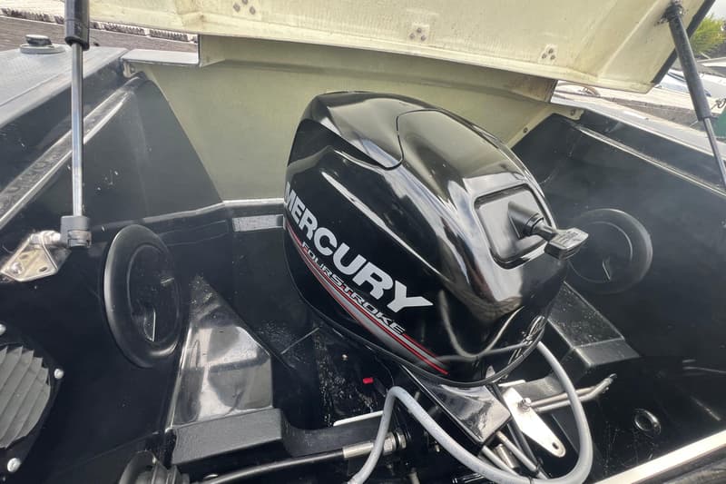 Een zwarte Mercury Fourstroke buitenboordmotor is gemonteerd op een boot met een open luik. — Corsiva 500 Tender